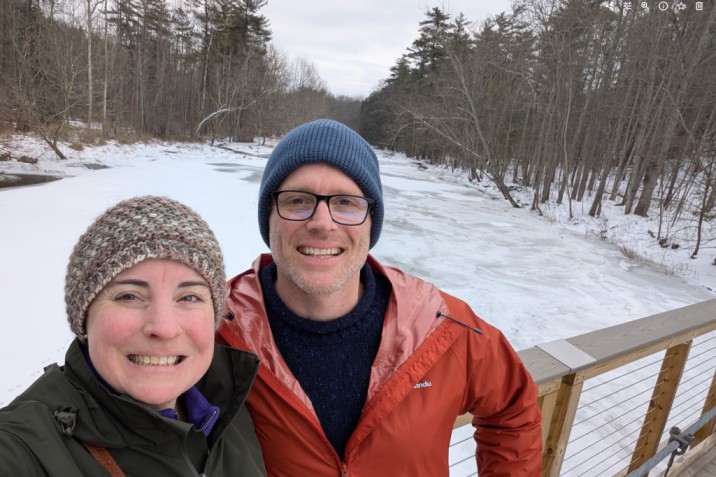 Adam Moody and Jeney Wierman on a bridge above a frozen stream in Ithaca